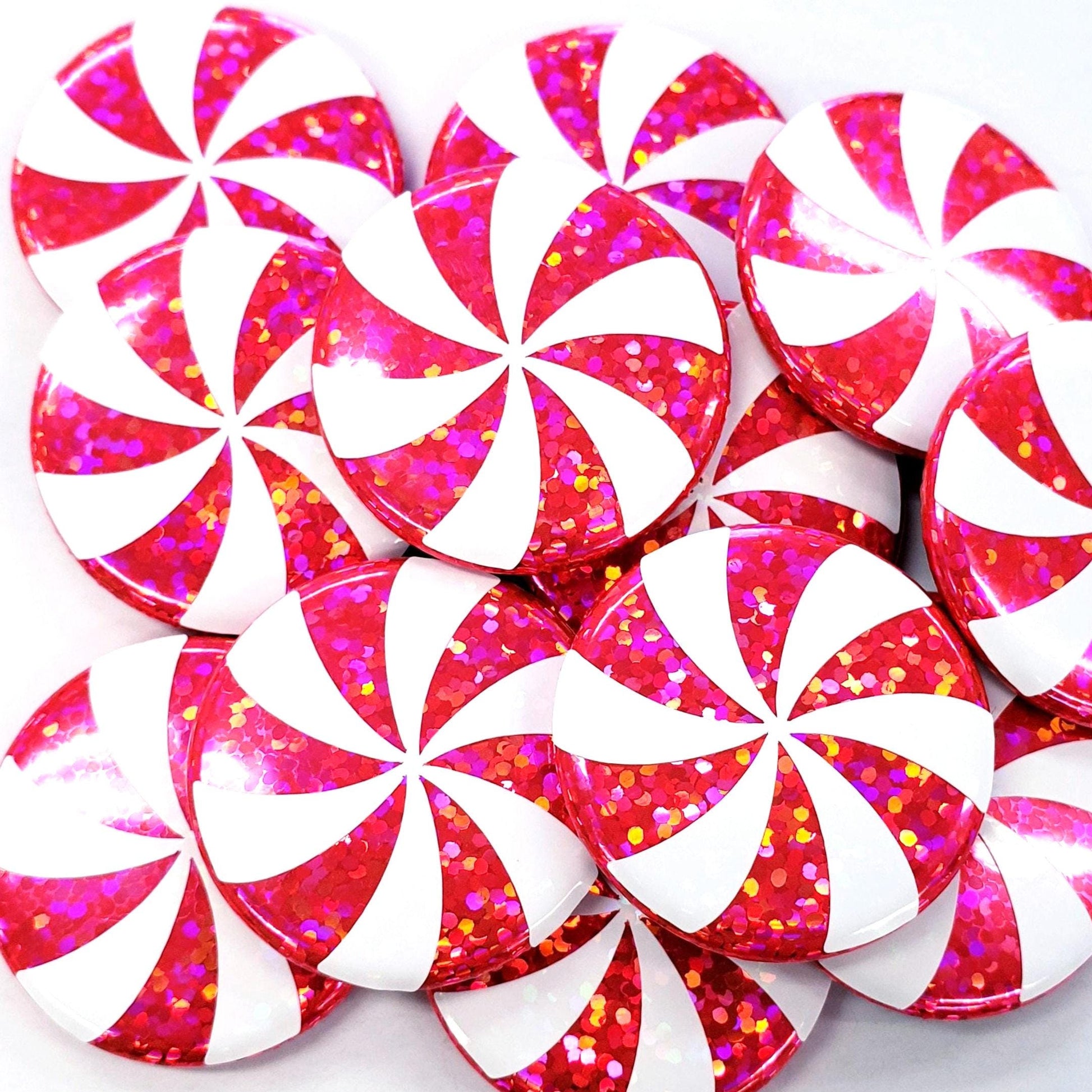 Pink and white peppermint candy magnets for metal surfaces.