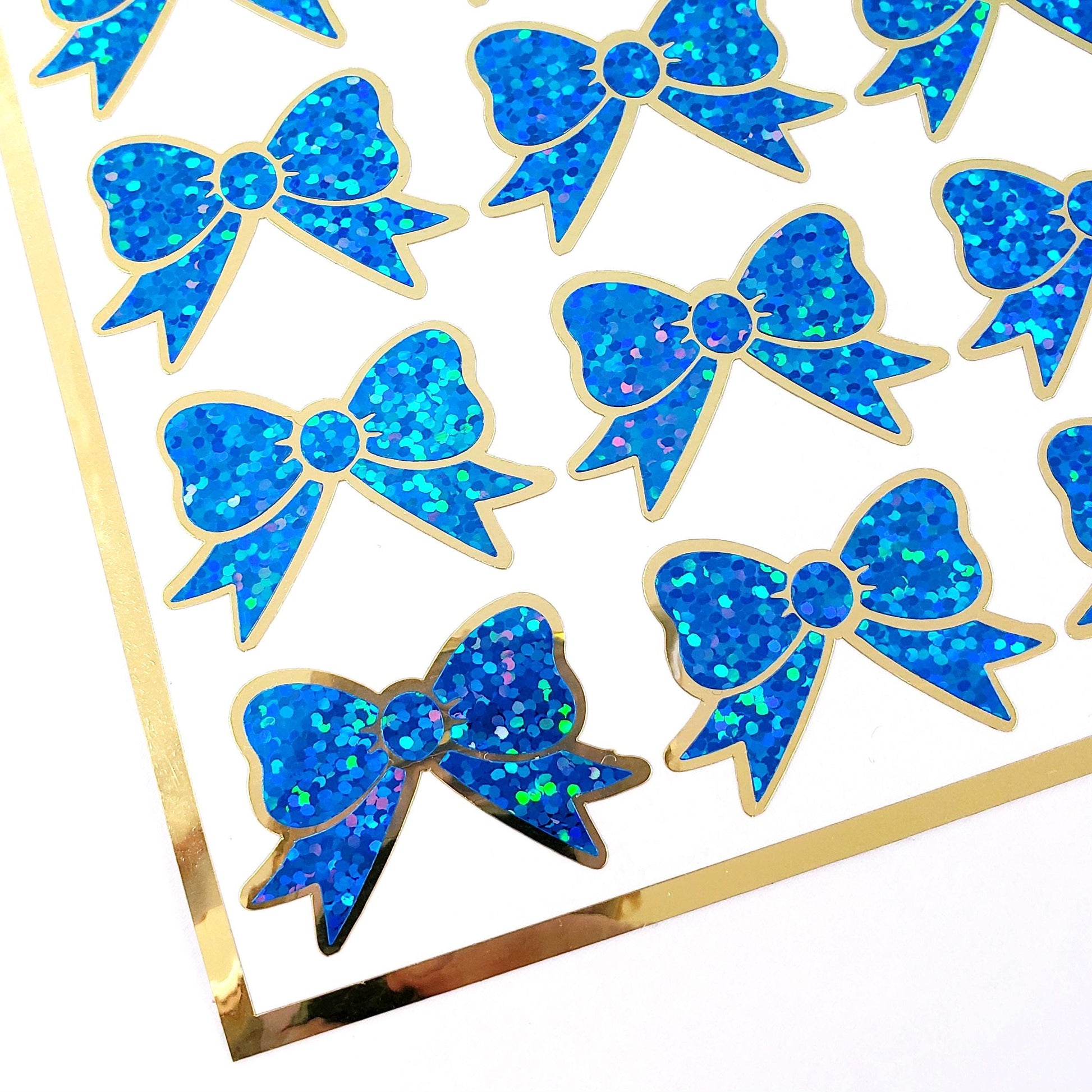 Blue Christmas Bow Stickers, set of 18 small sparkly ribbons for cards, journals, ornaments, laptops and craft projects, each 1.5 inches.