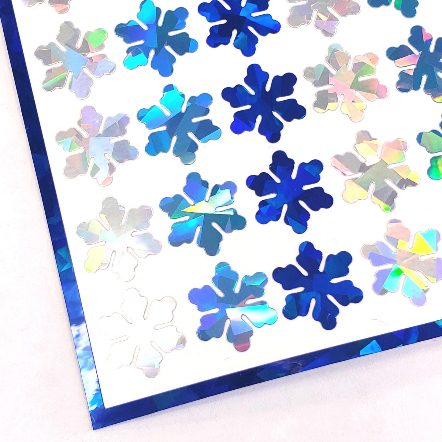 Blue and Silver Snowflake Stickers, set of 99 small sparkly snow embellishments for holiday cards, Christmas gift tags and winter crafts.