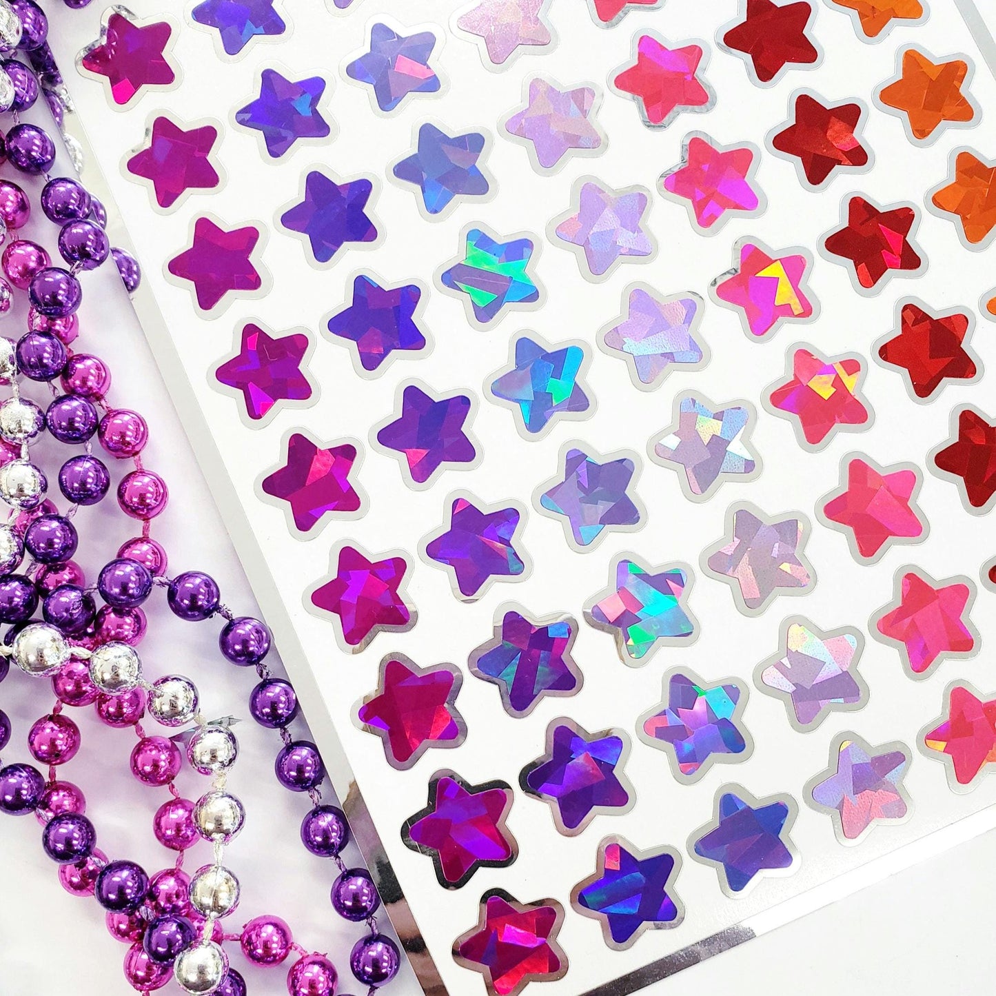 sparkly crystal stars sticker sheet in purples and pinks